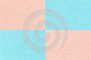Texture of craft light blue and pink paper background with cells pattern, macro. Vintage dense kraft rose cardboard