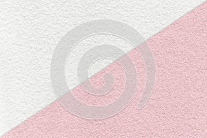 Texture of craft light pink and white paper background, half two colors, macro. Vintage dense kraft rose cardboard