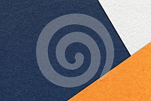Texture of craft navy blue color paper background with white and orange border. Vintage abstract denim cardboard