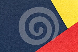 Texture of craft navy blue color paper background with yellow and red border. Vintage abstract denim cardboard.