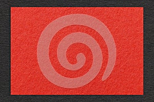 Texture of craft red color paper background with black border, macro. Structure of vintage dense kraft scarlet cardboard
