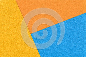 Texture of craft yellow, blue and orange shade color paper background. Structure of vintage abstract cardboard