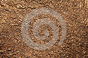 Texture of crumpled bronze foil.