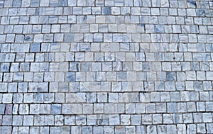 Texture of cubic stone paving on street.