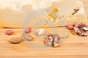 Texture of cut of maasdam cheese among of various nuts