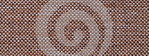 Texture of dark brown color background from woven textile material with wicker pattern, macro