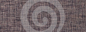 Texture of dark brown color background from woven textile material with wicker pattern, macro