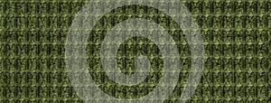 Texture dark green fluffy fabric background with rhomboid pattern, macro. Abstract backdrop from olive woven textile