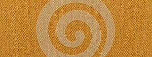Texture of dark orange color background from textile material with wicker pattern, macro. Vintage ocher fabric photo