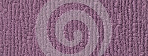 Texture of dark purple fluffy woolen textile background from soft fleecy material, macro. Structure of violet fabric