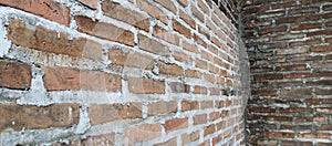 The texture of the dark red brick wall background is dark red brick wall, taken from a close-up