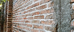 The texture of the dark red brick wall background is dark red brick wall, taken from a close-up