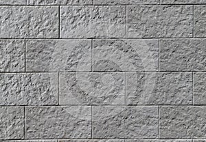 Texture of a decorative stone wall made of gray rectangular blocks photo