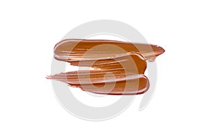 Texture of deep brown liquid foundation.Liquid foundation smudges isolated on white background
