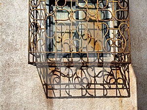 Texture and detail of an ornate vintage rusty metal grill