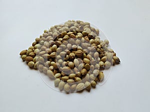 Texture of Dhaniya Seeds. Heap of a Coriander or Dhania Seeds  in a white Background