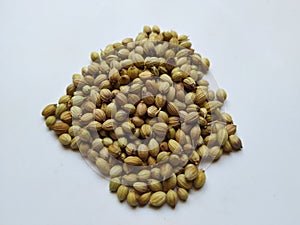 Texture of Dhaniya Seeds. Heap of a Coriander or Dhania Seeds  in a white Background