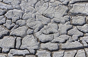 The texture of dried cracked mud flowed out of a mud volcano