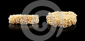 Texture of dry instant noodles isolated on black background. Raw dried Instant ramen noodles block isolated