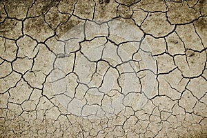 Texture of the dry land with cracks in the soil, drought on the ground