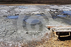 Texture of the earth`s surface and cracks next to the cold mud volcano. The layer of mud, which volcano erupts, quickly dries up