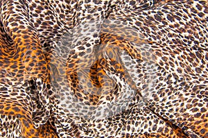 Texture, fabric, background. Beautiful silk scarf with a predatory pattern