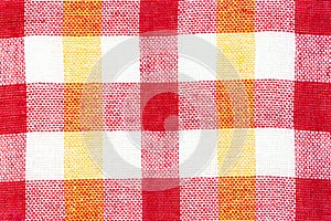 Texture of fabric with a bright checkered pattern. Christmas. Scrapbooking. Napkin, knitting, eyelets,