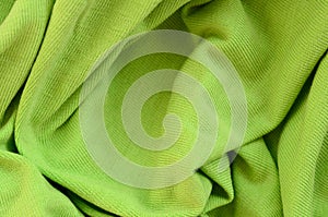 The texture of the fabric is bright green. Material for making s