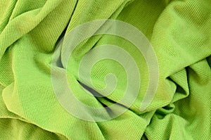 The texture of the fabric is bright green. Material for making s