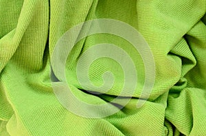 The texture of the fabric is bright green. Material for making s