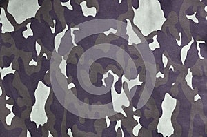 Texture of fabric with a camouflage painted in colors of the marsh. Army background image. Textile pattern of military camouflage