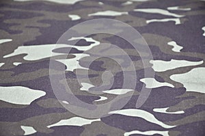 Texture of fabric with a camouflage painted in colors of the marsh. Army background image. Textile pattern of military camouflage