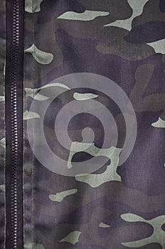 Texture of fabric with a camouflage painted in colors of the marsh. Army background image. Textile pattern of military camouflage