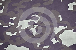 Texture of fabric with a camouflage painted in colors of the marsh. Army background image. Textile pattern of military camouflage