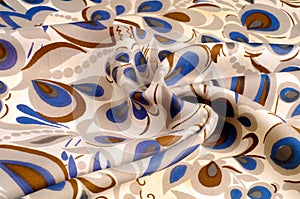 texture fabric with a color pattern, brown, blue, light flowers.