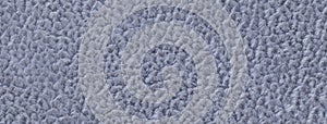 Texture of fluffy woolen cool gray textile background from soft fleecy material, macro. Structure of blue fabric