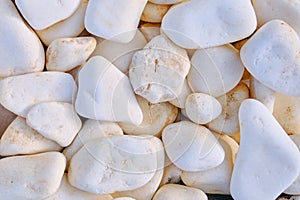 Texture in the form of white rocks. Background of large white stones. Round stone texture, close-up