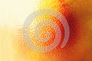 Texture of fresh bright orange peel, closeup, copy space. Macro of orange fruit. Citrus fruit background