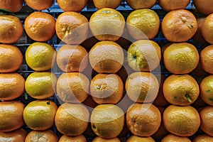 Texture of fresh mandarin oranges in supermarket, citrus fruit photo