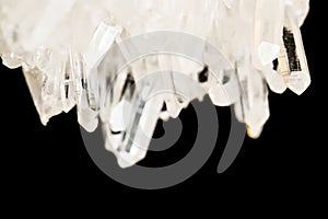 Texture of gemstone clear rhinestone closeup as a part of cluster geode filled with rock Quartz crystals.