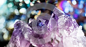Texture of gemstone lilac Amethyst closeup as a part of cluster geode filled with rock Quartz crystals.