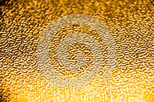Texture of the gold embossing of cardboard close up