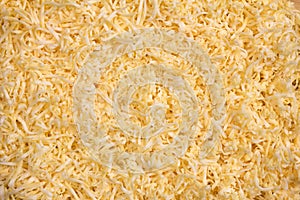 The texture of grated cheese. Orange cheese. Close up