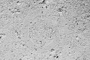 Texture of gray concrete with recesses of different sizes