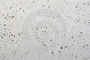 Texture of a gray concrete wall with small depressions