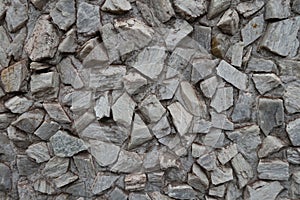 Texture of gray gravel pebble dash on the wall