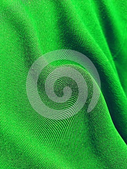 The texture of the green cloth is wavy. Abstract background with striped pattern.