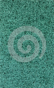 Texture of green sponge for washing dishes, close-up