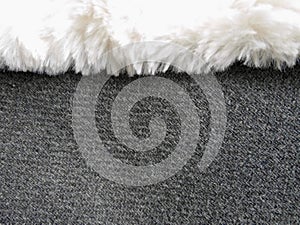 Texture of grey fabric with white fur, close up of sheep wool structure, wallpaper background.