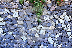 Texture of a grey granite stone wall for background